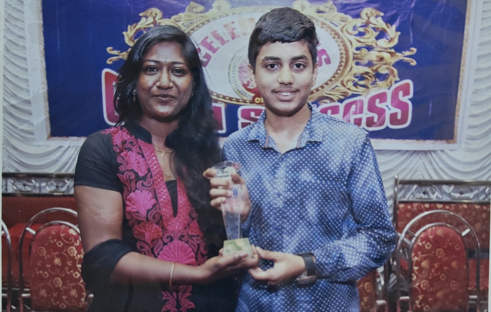 Student felicitated on stage by faculty